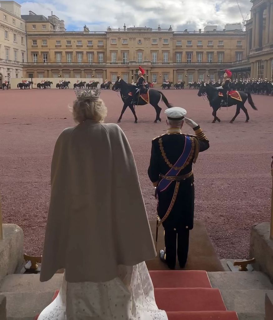 Queen Camilla wearing white cape 