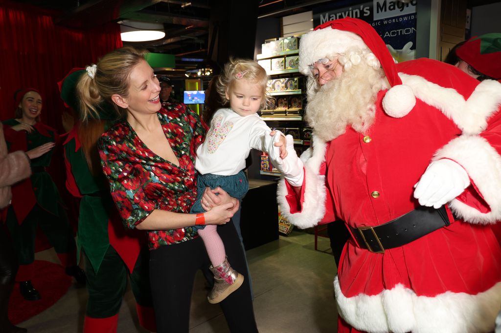 Rachel Riley and kid dance with Santa during the VIP launch party for Christmas at Hamleys on November 09