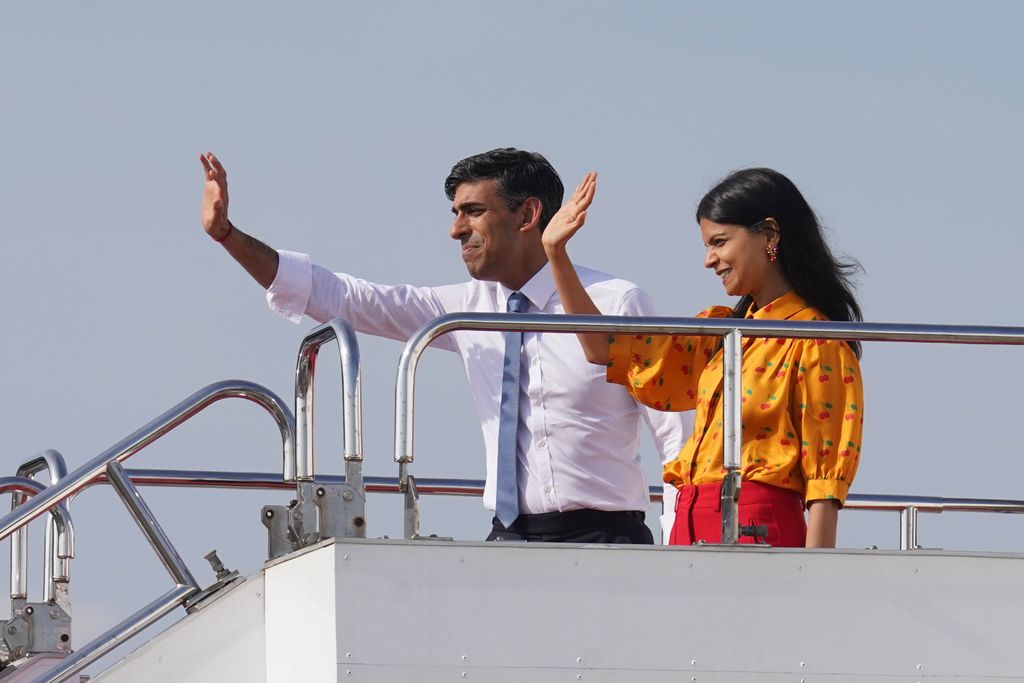 British Prime Minister Rishi Sunak and wife Akshata Murty wave as they board a plane in Hiroshima, after the G7 Summit on May 21, 2023 in Hiroshima, Japan.
