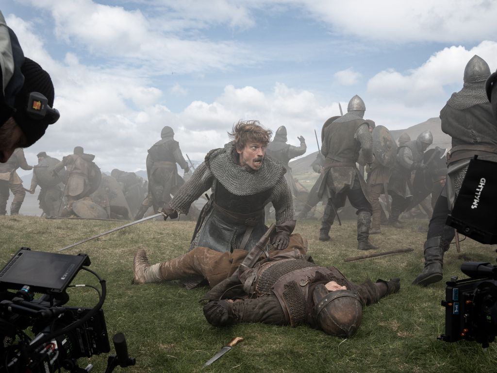 A man holds a man to the floor in battle