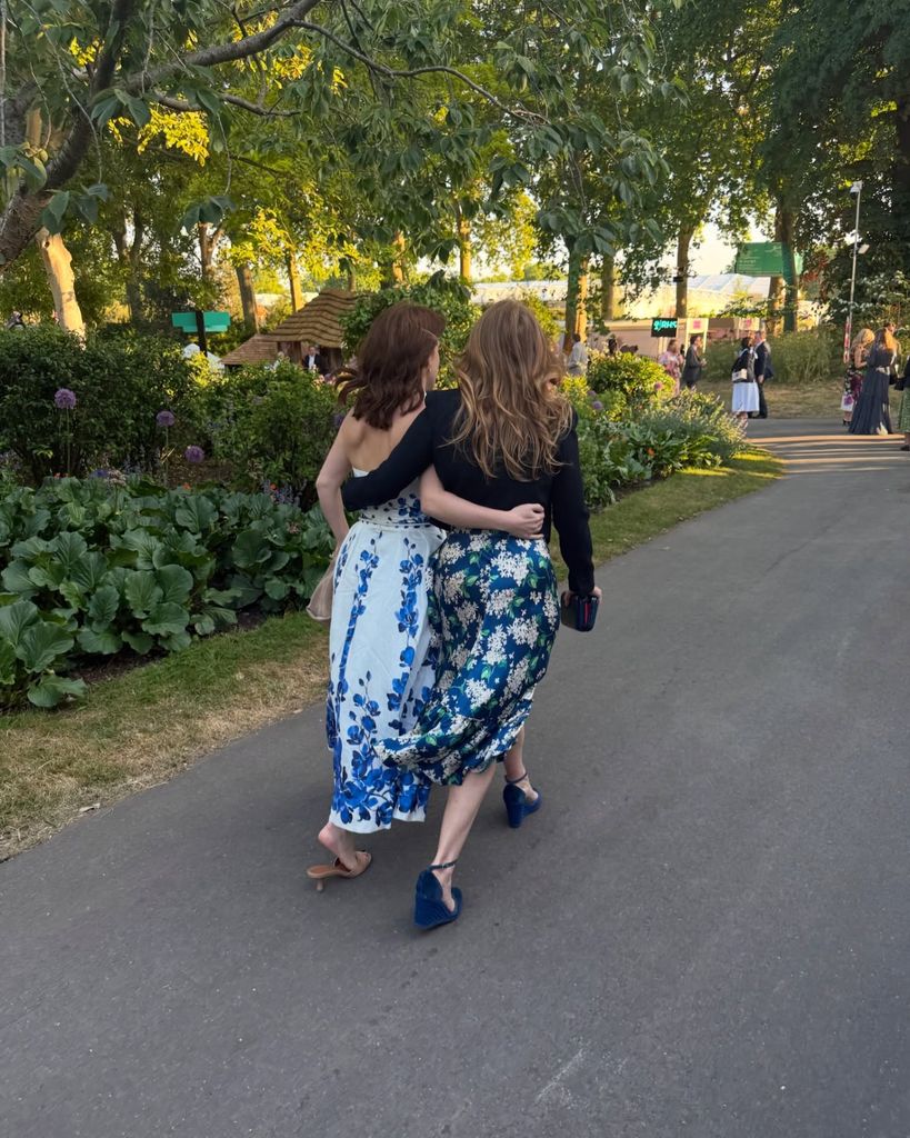 Princess Eugenie and Princess Beatrice walk with arms around each other at Chelsea Flower Show