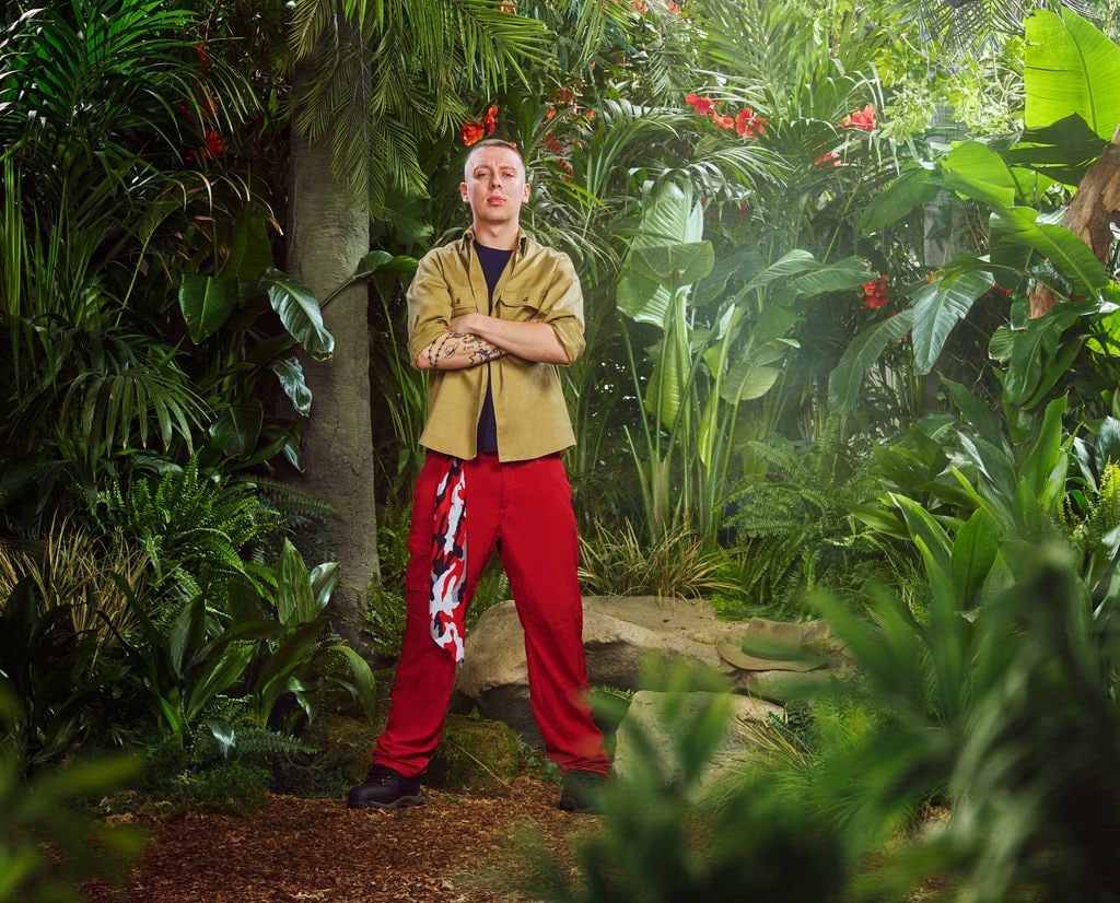 person in red and beige uniform in jungle setting