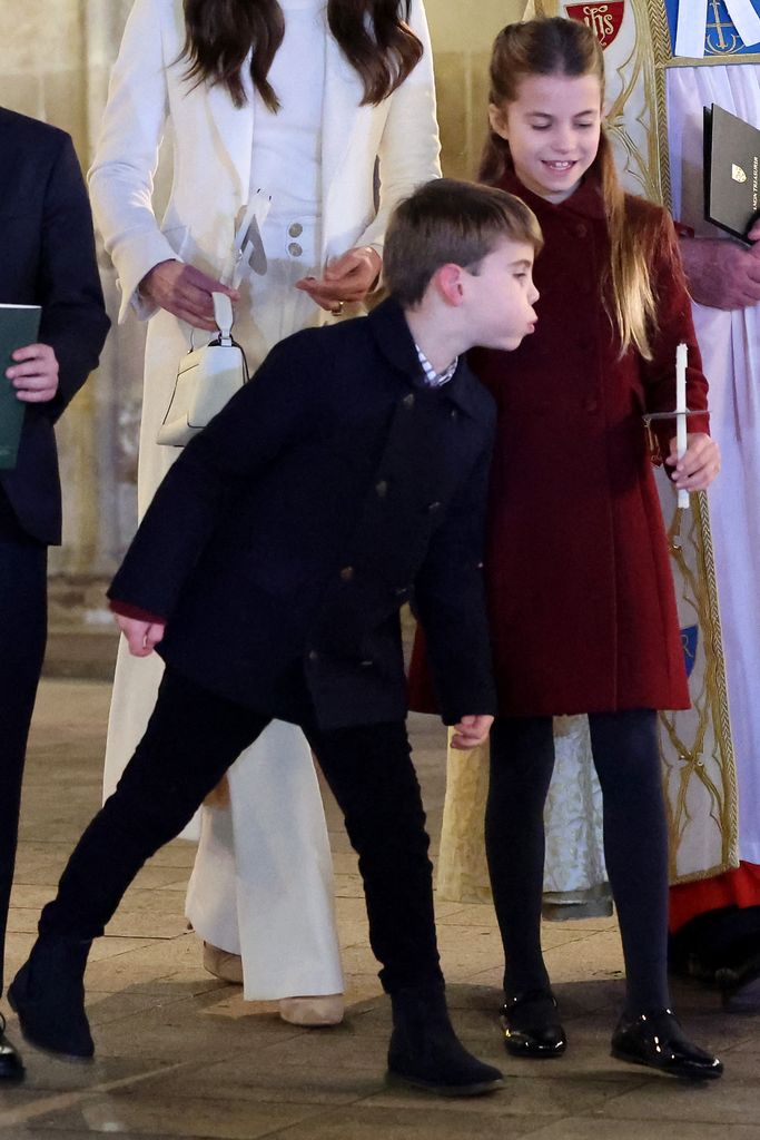 Playful Prince Louis blew out his sister's candle during the service