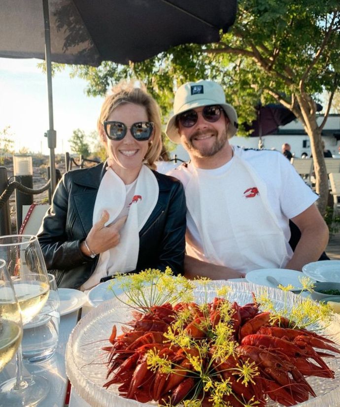 Tiffany Cromwell and Valtterri Bottas in front of plate of shrimp