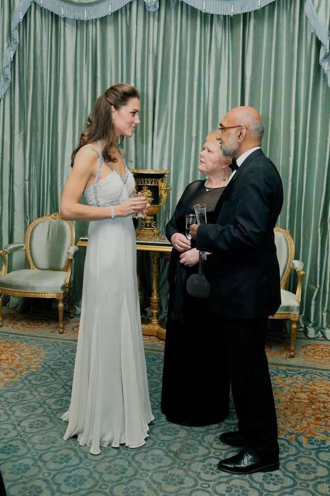 Kate speaks to guests at Clarence House in pale gown