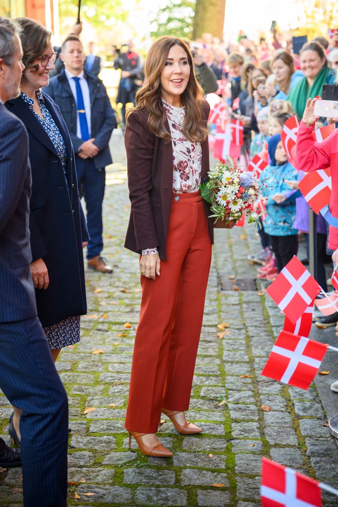 Queen Mary wearing unexpected orange trousers greeting public