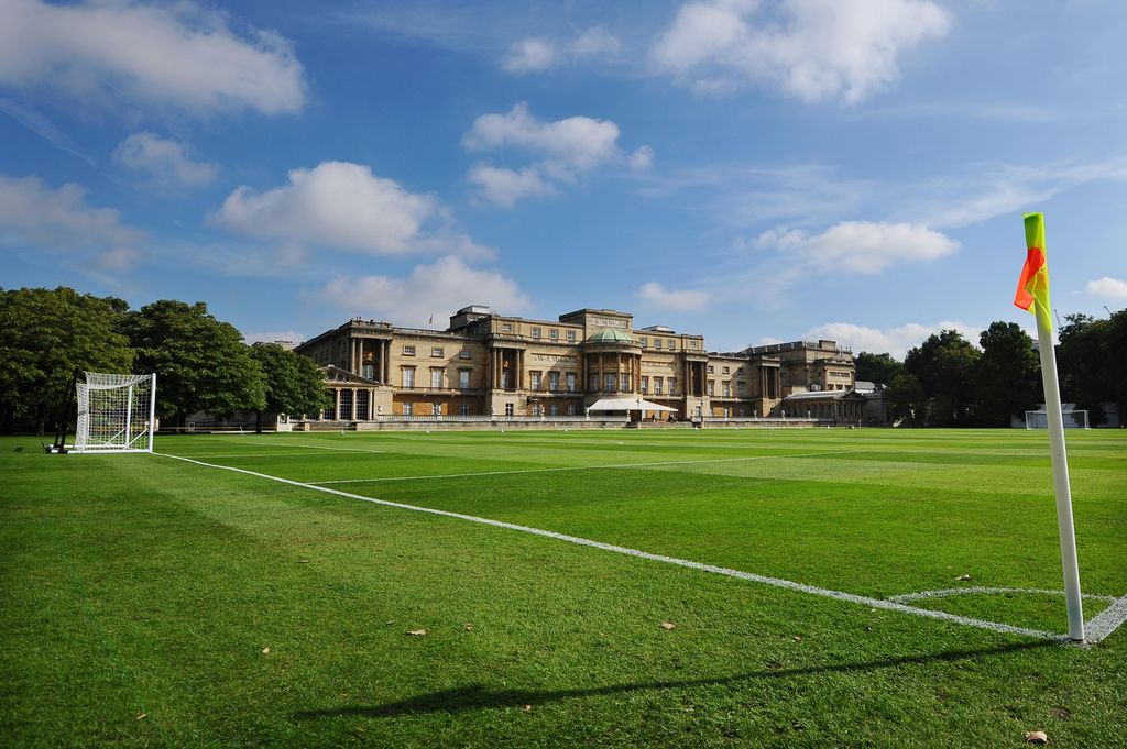 A football field with a conservatory in the distance