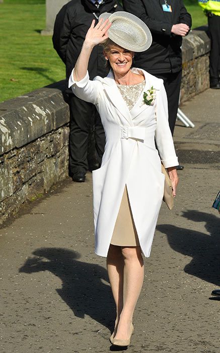 Judy Murray in a white coat waving