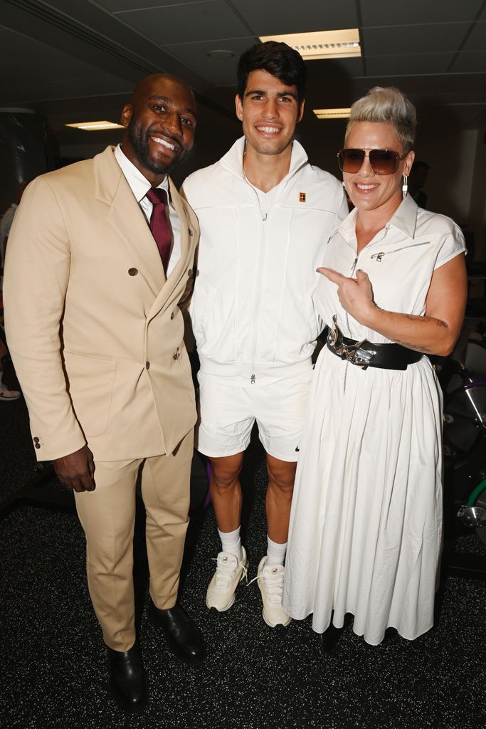 Pink meets Carlos Alcaraz (center) on day ten of the Wimbledon Tennis Championships at the All England Lawn Tennis and Croquet Club 
