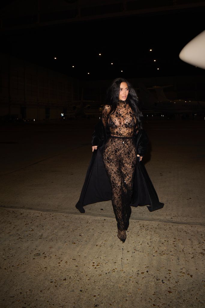 Kim Kardashian wearing a black lace catsuit from Balenciaga