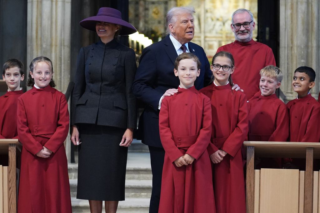 US President Donald Trump and US First Lady Melania Trump pose with a children's choir during a tour of St George's Chapel during the State visit by the President of the United States of America at Windsor Castle on September 17, 2025