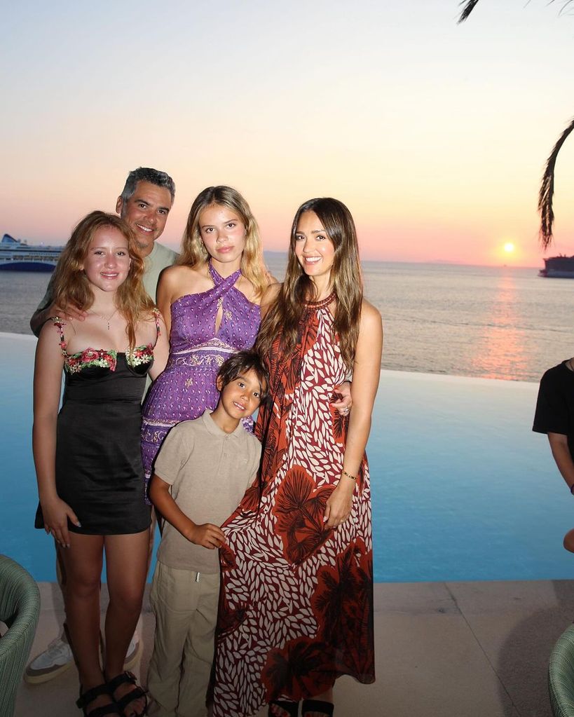 Jessica Alba (RIGHT) poses with her family in Mykonos in front of a sunset 