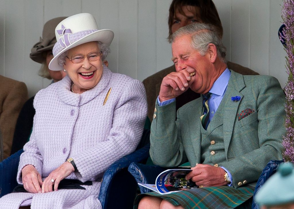 Queen and Charles laughing together at The 2012 Braemar Highland Gathering