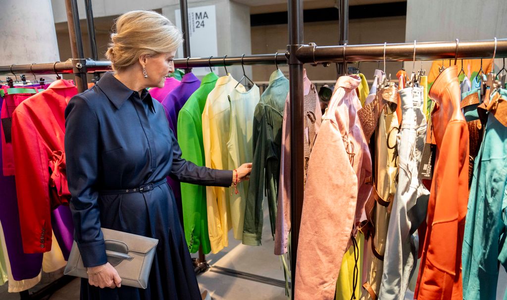 Sophie looking at clothes on rail