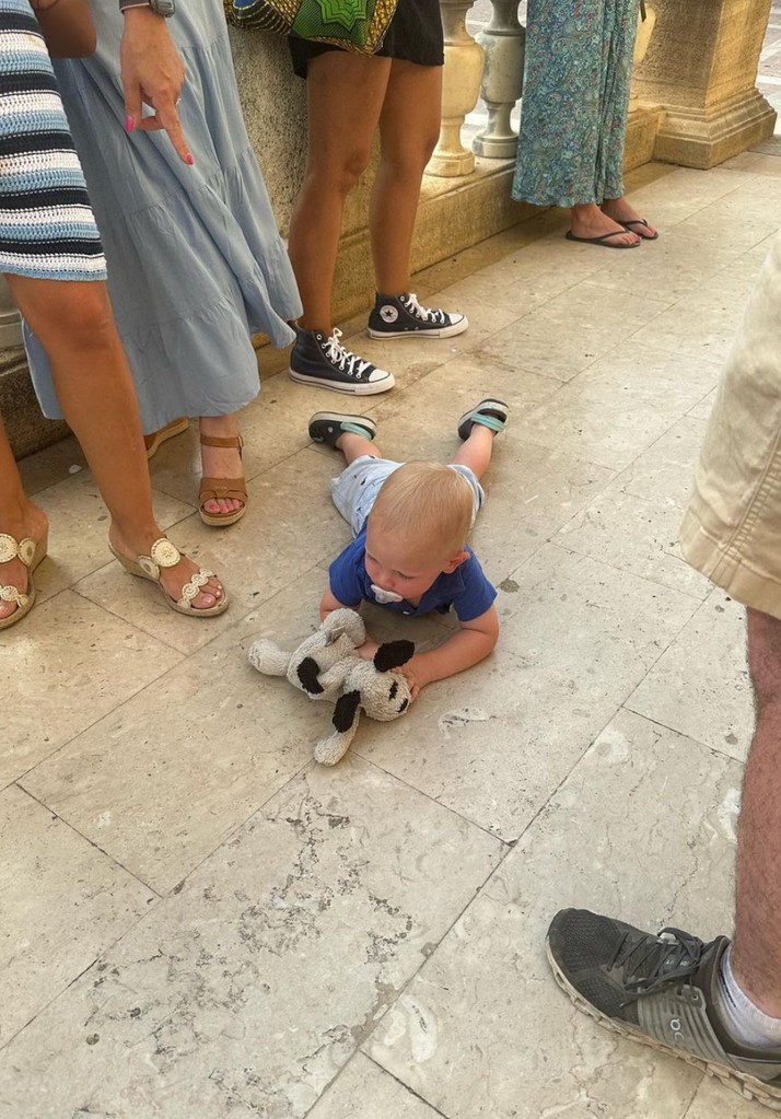 Photo shared by Dylan Dreyer on Instagram july 2023 of her youngest son, Russell "Rusty" Fichera laying down on the floor during the family's trip to Italy.