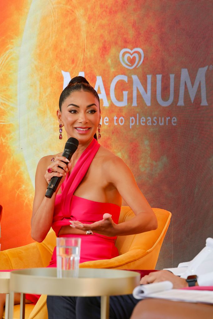 nicole scherzinger pink top holding microphone panel discussion cannes