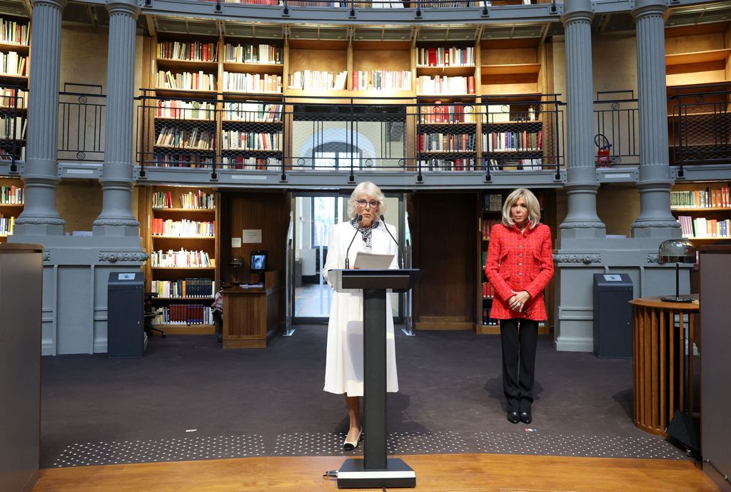 Britain's Queen Camilla (L) delivers a speech next to French President's wife Brigitte Macron during their visit to the "Bibliotheque Nationale de France" 