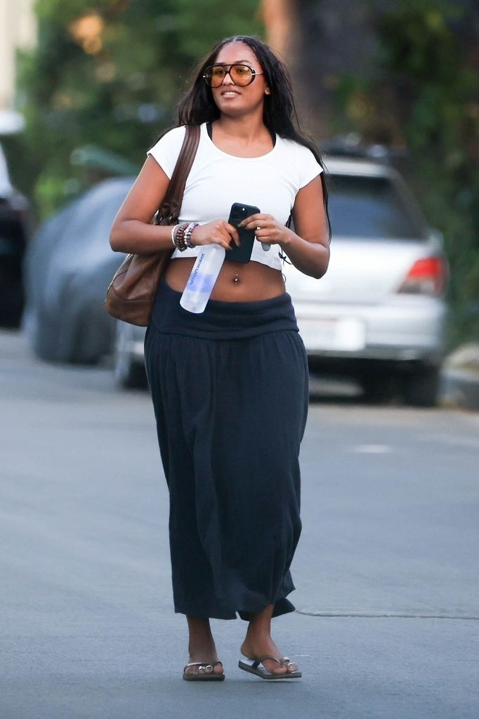 health *EXCLUSIVE* Los Angeles, CA   Sasha Obama beams in good spirits as she flaunts her toned abs in a chic crop top and maxi skirt ensemble while arriving at a friendâ€™s house in West LA
