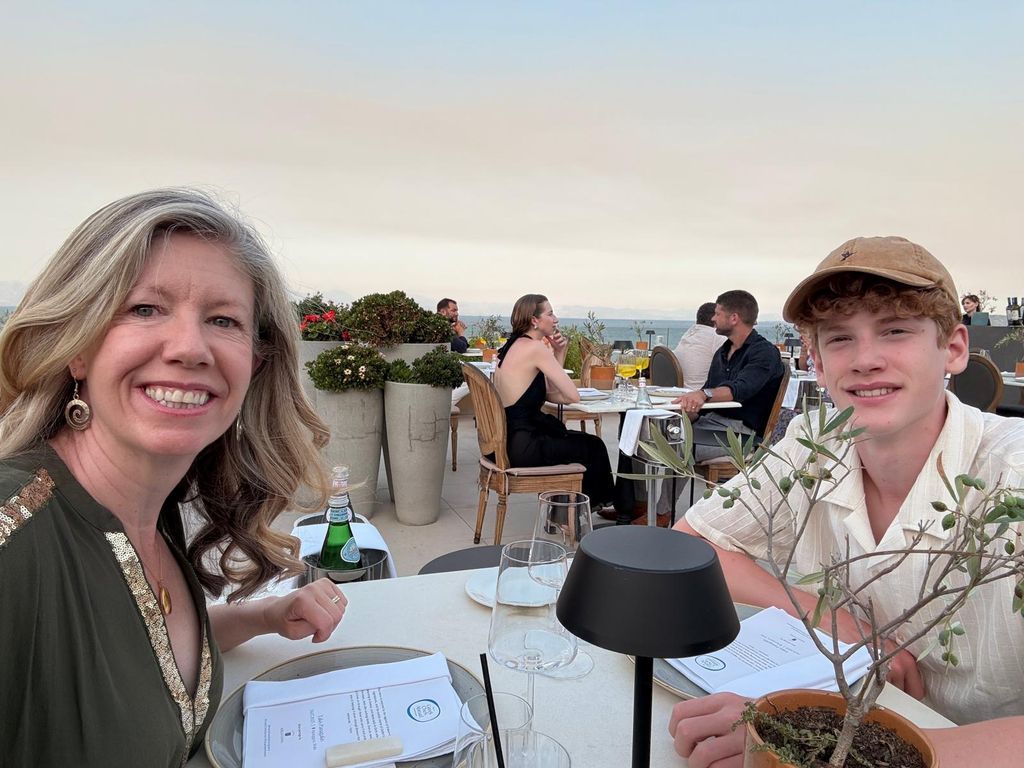 a mother and her teenage son dining on a rooftop in Greece