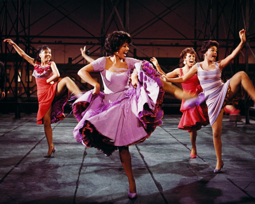 Rita Moreno, Puerto Rican actress, singer and dancer, wearing a short-sleeved lilac dress, dancing in a publicity image issued for the film adaptation of 'West Side Story', 1961
