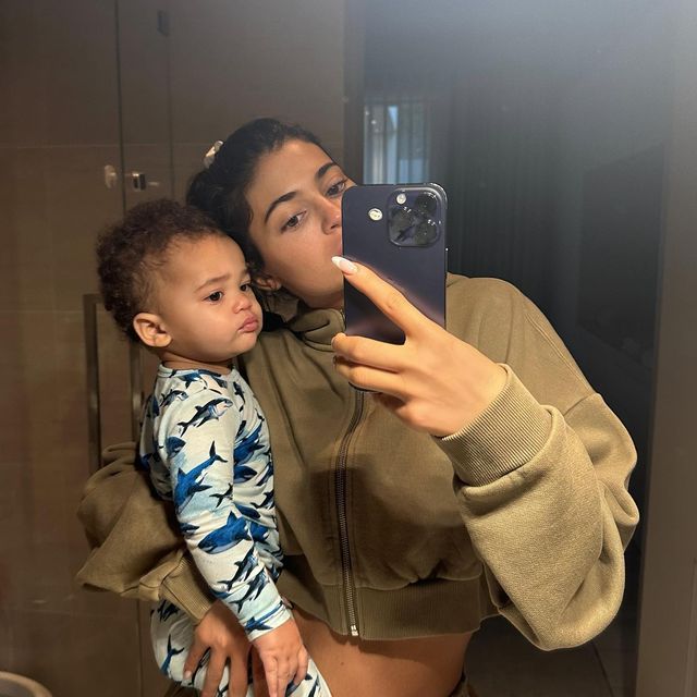 Kylie holding Aire posing for a mirror selfie