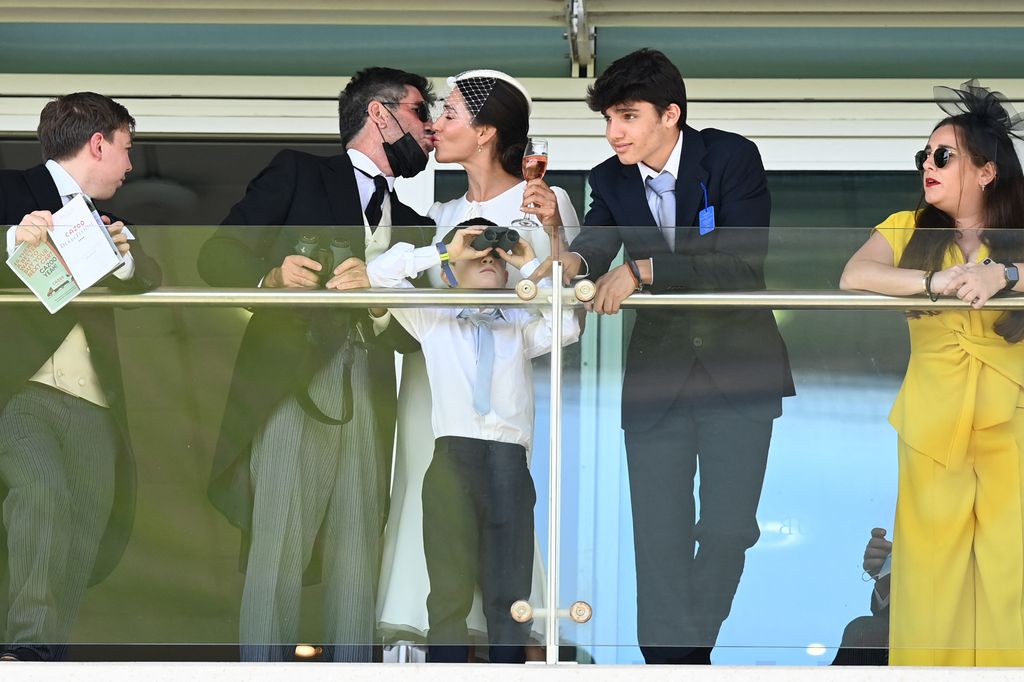 Simon Cowell and US socialite Lauren Silverman along with their children Eric and Adam, kissing at the Epsom Derby 