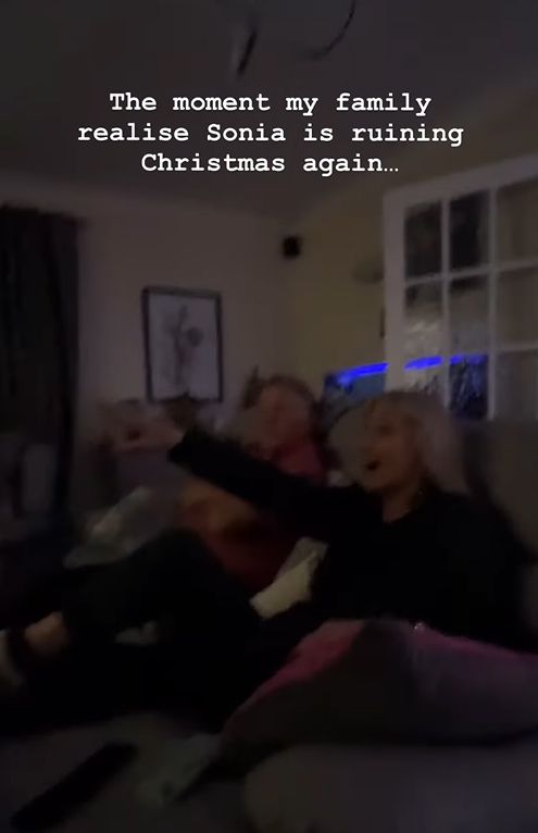 Grainy photo of two elderly people watching TV