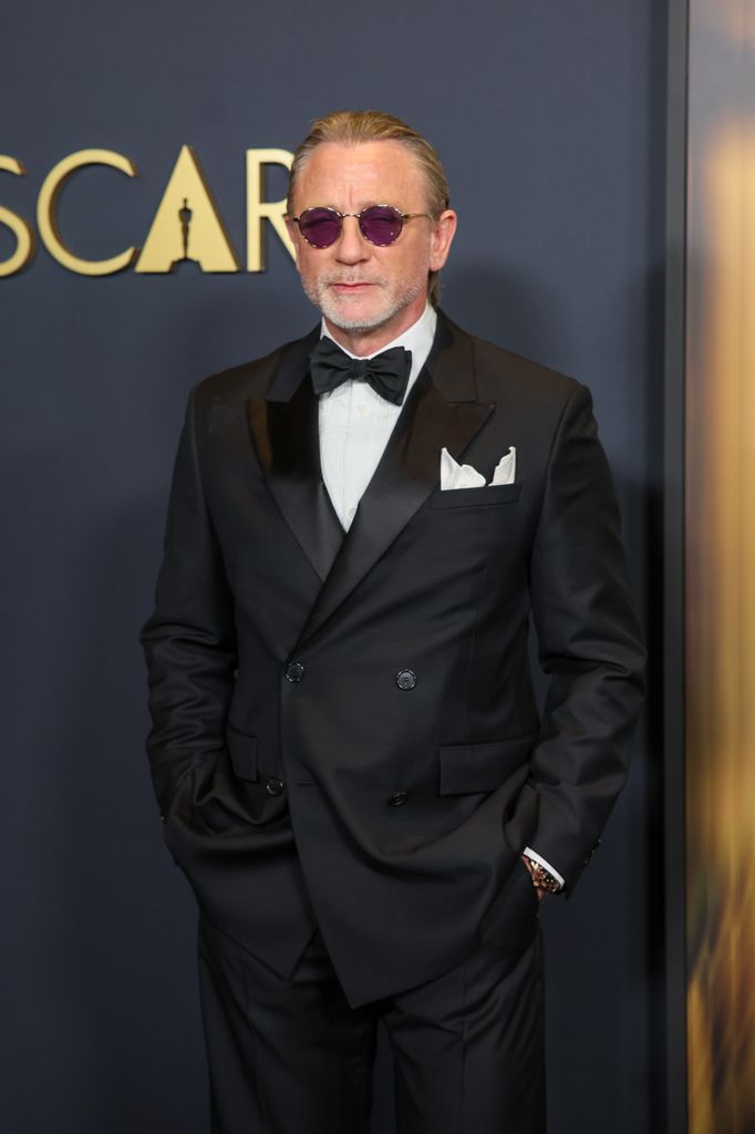 actor in black tuxedo and glasses