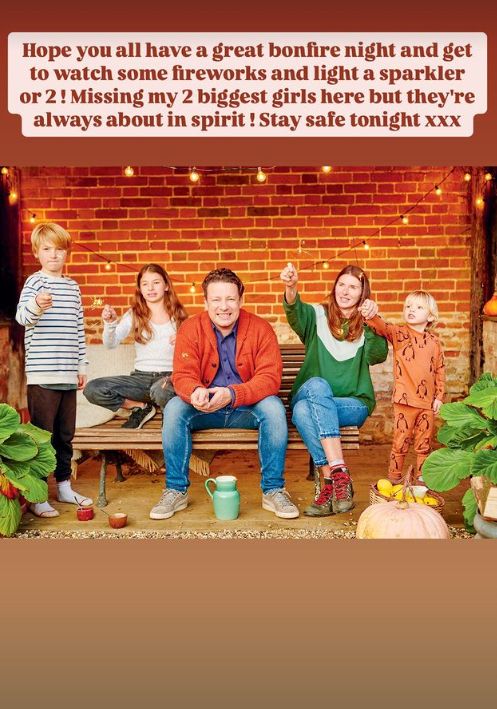 Jamie and Jools Oliver with three of their children holding sparklers