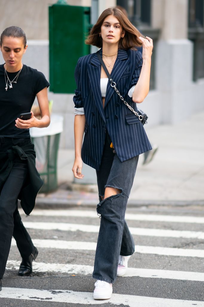 kaia gerber in ripped jeans and a blazer