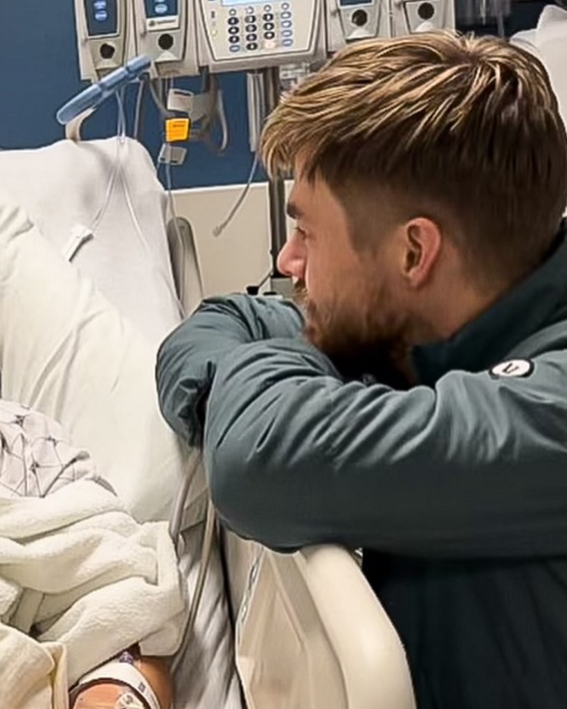 Photo shared by Derek Hough December 2023 leaning on Hayley Erbert's hospital bed following a successful craniectomy