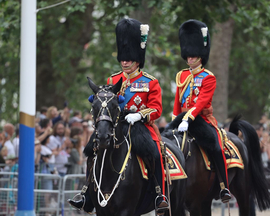 Charles and William ride on horseback during Trooping the Colour