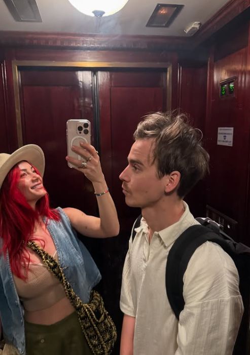 Dianne Buswell and Joe Sugg taking a photo inside an elevator