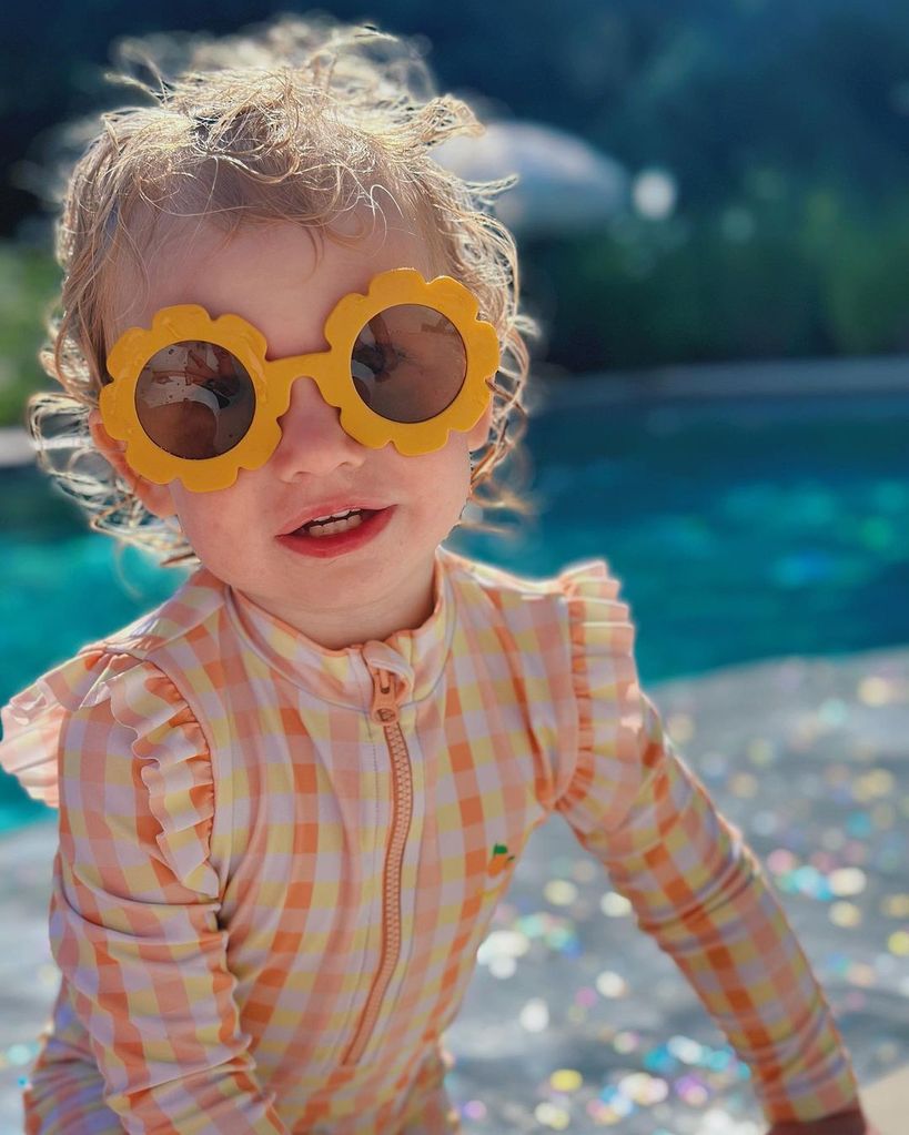 Rose Swash in sunglasses by her family's swimming pool