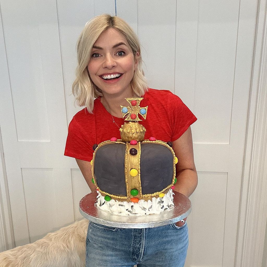Holly in jeans holding crown cake