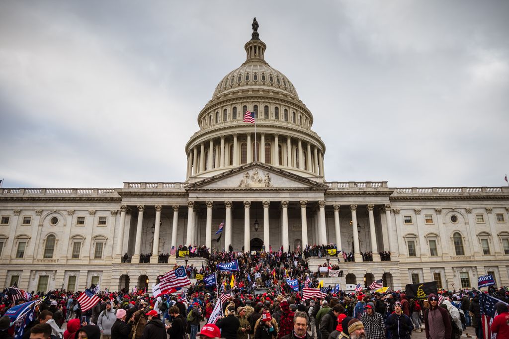 A large group of pro-Trump protesters stand on the East steps of the Capitol Building after storming its grounds on January 6, 2021 in Washington, DC. A pro-Trump mob stormed the Capitol, breaking windows and clashing with police officers. Trump supporters gathered in the nation's capital today to protest the ratification of President-elect Joe Biden's Electoral College victory over President Trump in the 2020 election