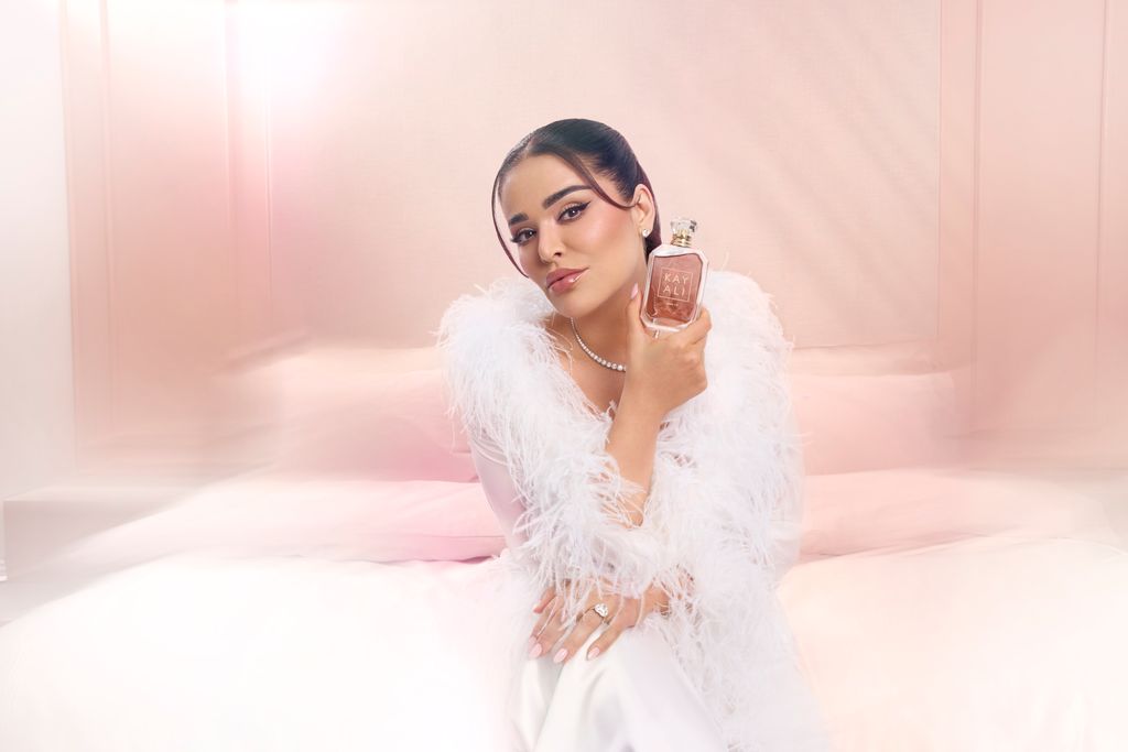 Kayali founder Mona Kattan posing with Musk 12 bottle