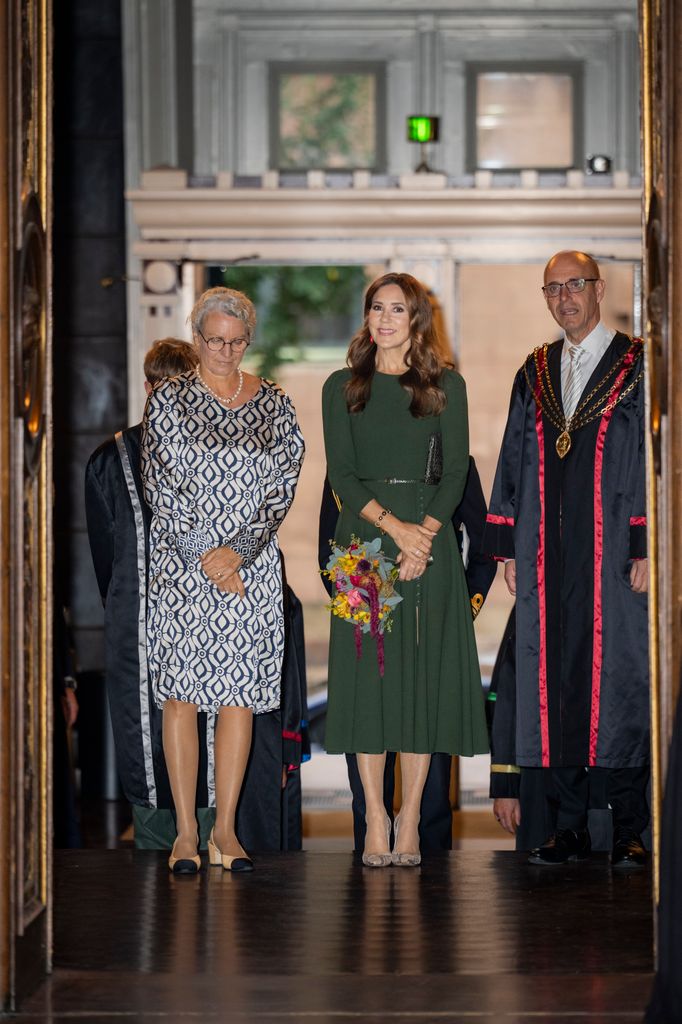 Queen Mary arrives at Copenhagen University hall in green a-line dress