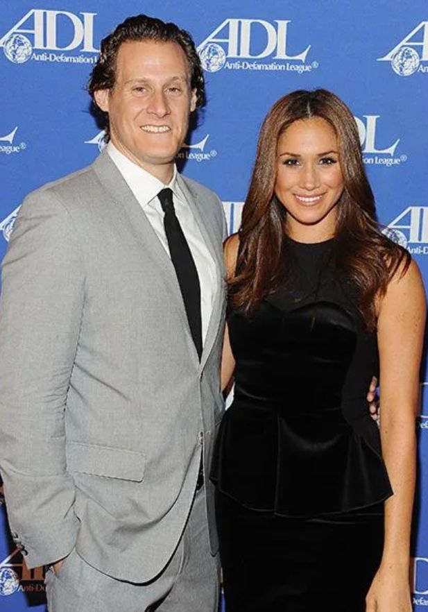 Trevor Engelson standing with Meghan Markle