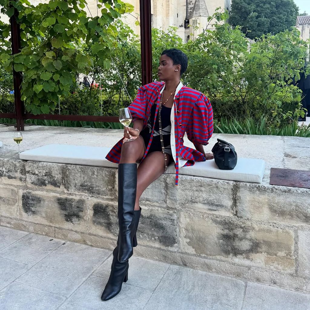 Eva Apio in stripe top and leather boots