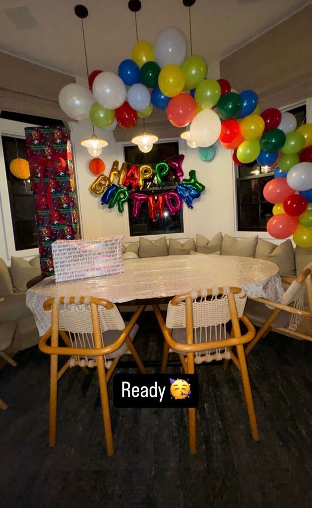 photo of a balloon arch and happy birthday balloons around a table at Jessica Alba's home 