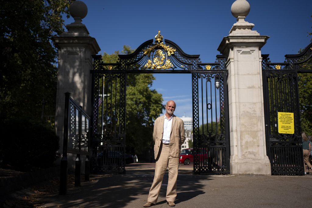 Martin Jennings standing outside a pair of iron gates
