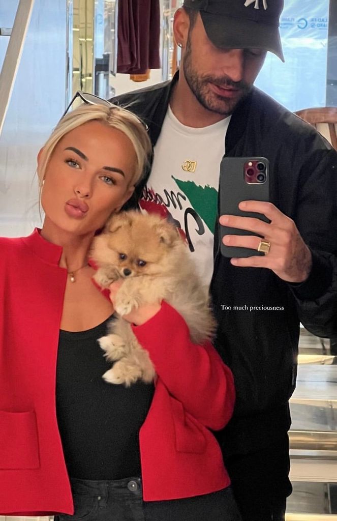 Molly Brown and Giovanni Pernice posing with a puppy