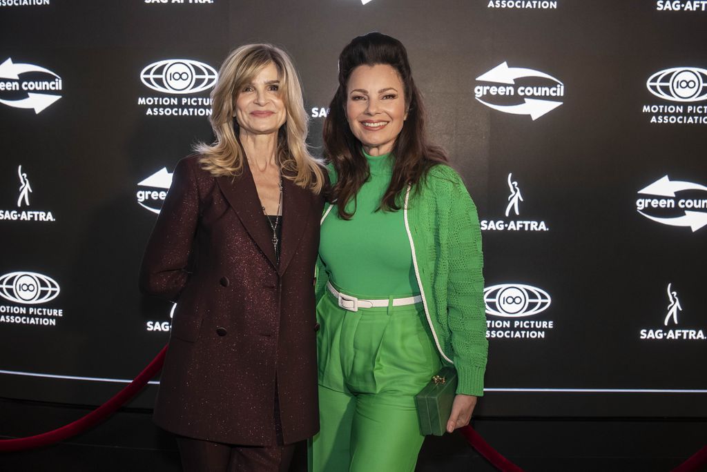 Kyra Sedgwick in burgundy and Fran Drescher in green