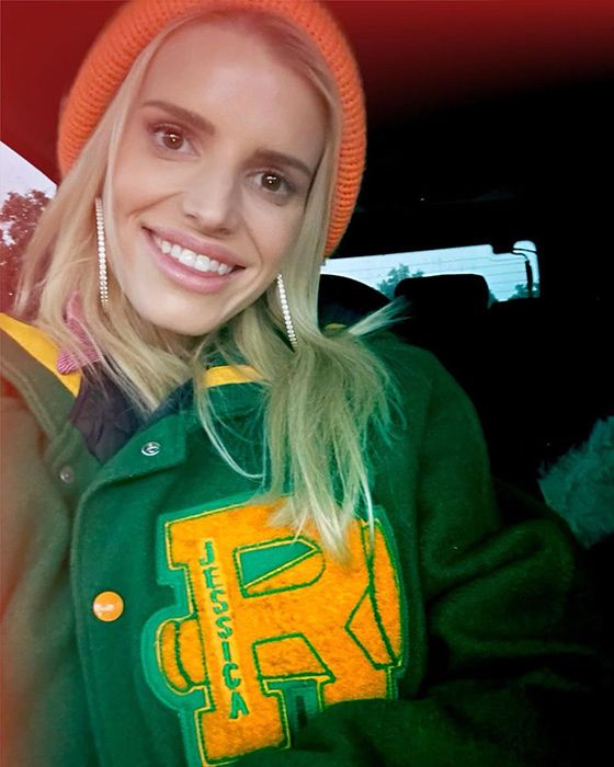 Jessica Simpson smiles as she wears her cheerleading jacket from the eighth grade