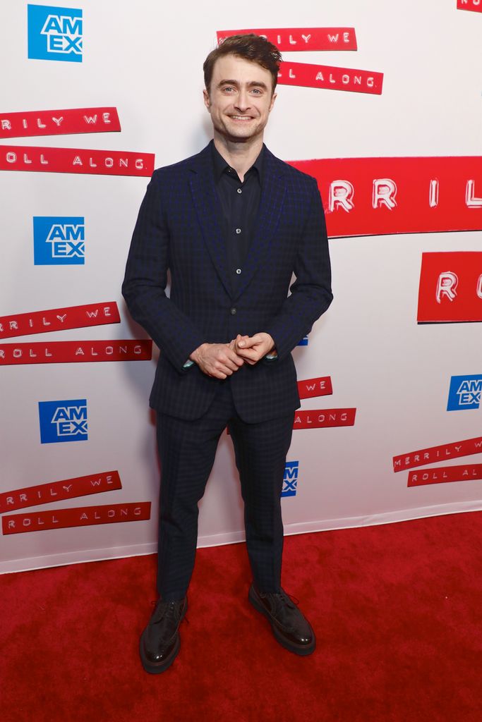 Danielle Radcliffe wears a checkered suit