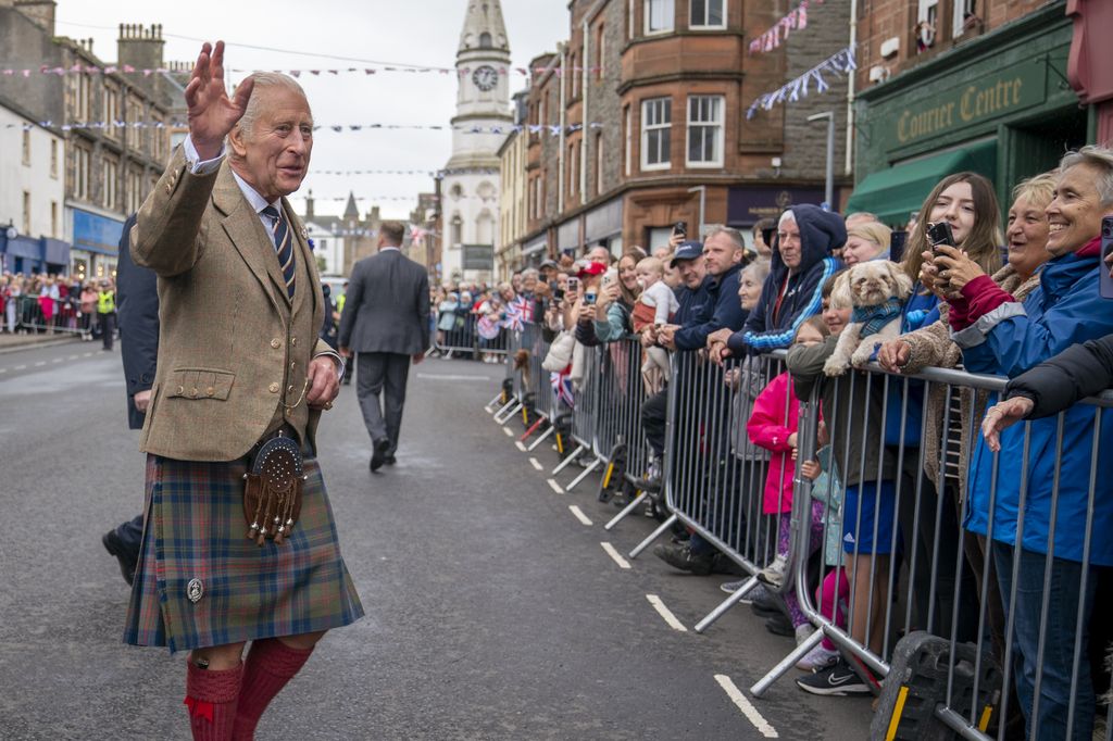 King Charles meets members of the public waving