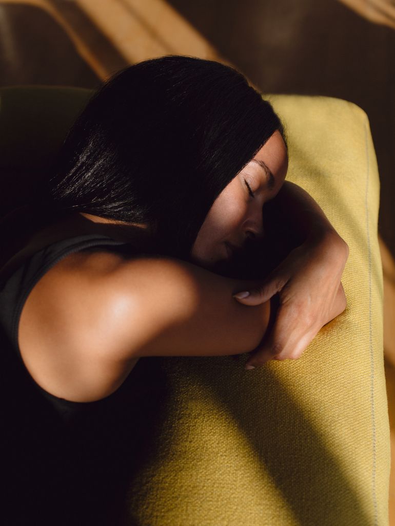 woman lying on a yellow pillow