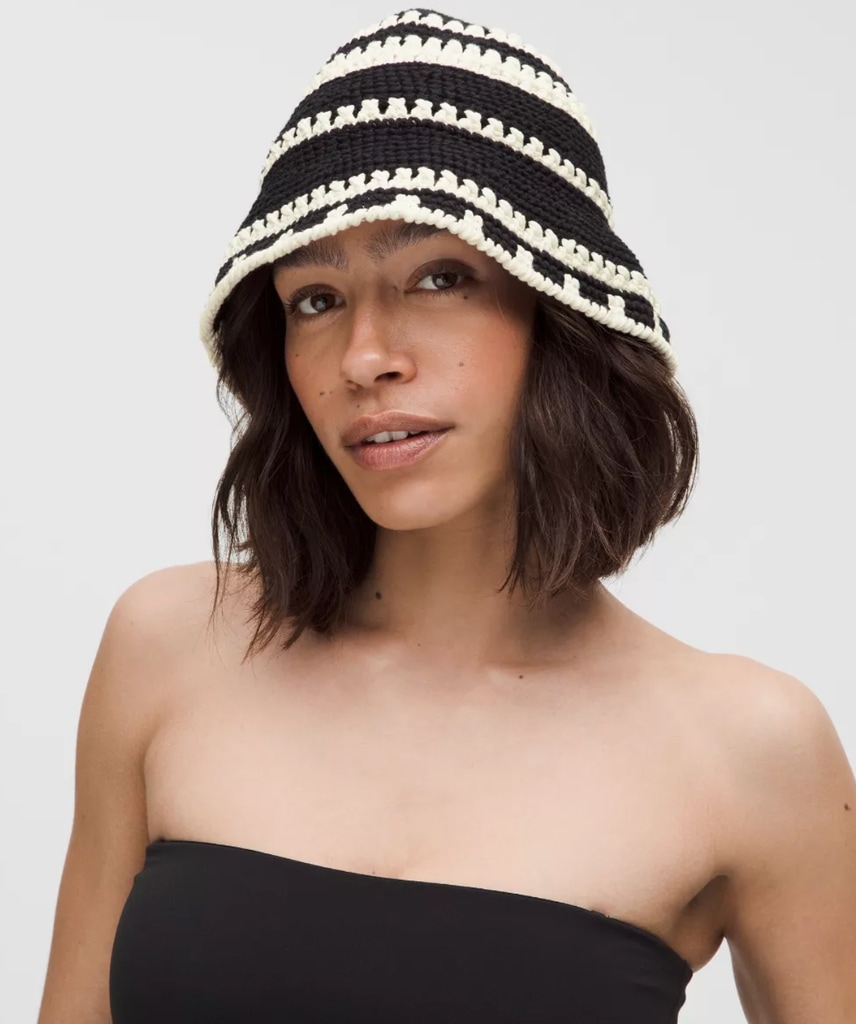 A model wears a stripe black and white bucket hat 