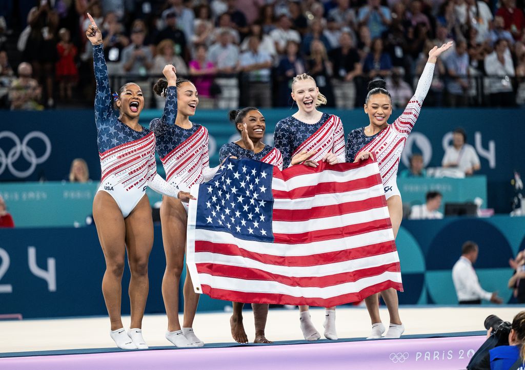 Jordan Chiles, Hezly Rivera, Simone Biles, Jade Carey, Sunisa Lee of USA celebrate victory while the womenÂ´s team final with the USA flag  on day four of the Olympic Games Paris 2024 at Bercy Arena on July 30, 2024 in Paris, France